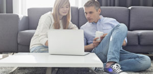 Young couple working at home on laptop